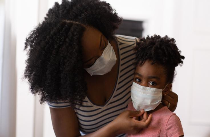 Parent adjusts mask on child 
