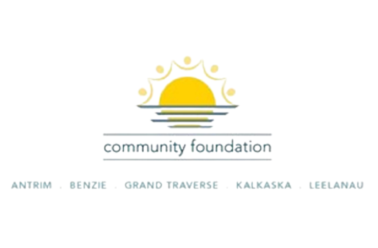 Grand Traverse Regional Community Foundation Logo with a sun like image rising from and reflecting on a water horizon