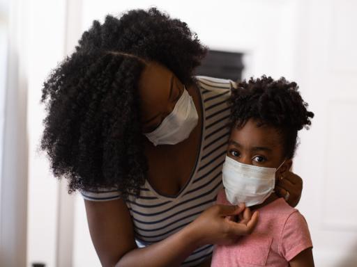 Parent adjusts mask on child 