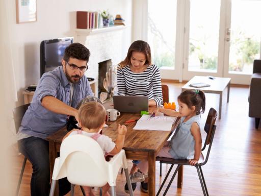 Family together in the living room, working and playing.