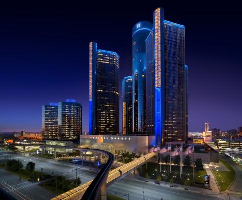 View of the Renaissance Center in Downtown Detroit in the evening with highlighted lights and blue accents