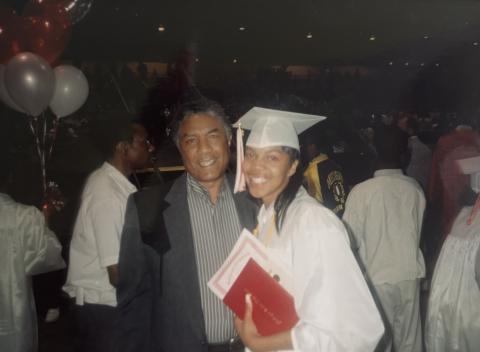 An image of Camarrah Morgan and he Grandfather smiling during her graduation.