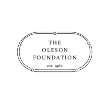 The Oleson Foundation Logo with "est. 1962" under the name of the foundation in all caps and all is encircled by an oval drawn with two thin lines and five circles spaced equal distance around the oval lines