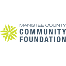 Manistee County Community Foundation Logo with text on the right and a green-yellow flower on the left