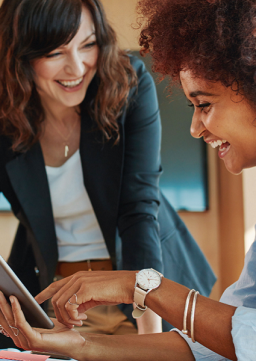 Photo of women working together happily