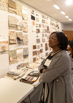 Woman looking at textile samples during a tour of a La-Z-Boy building
