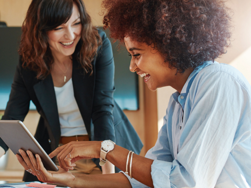 Photo of women working together happily