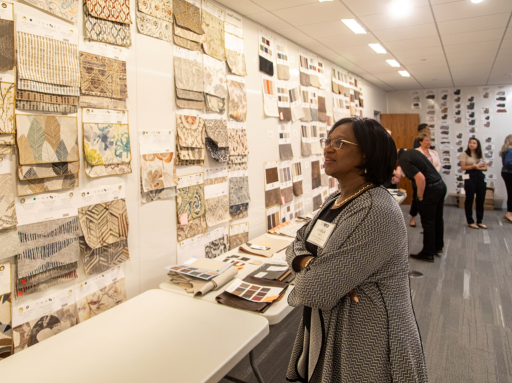 Woman looking at textile samples during a tour of a La-Z-Boy building