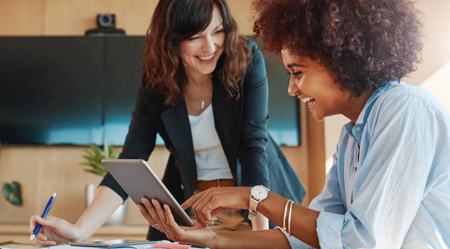 Photo of women working together happily