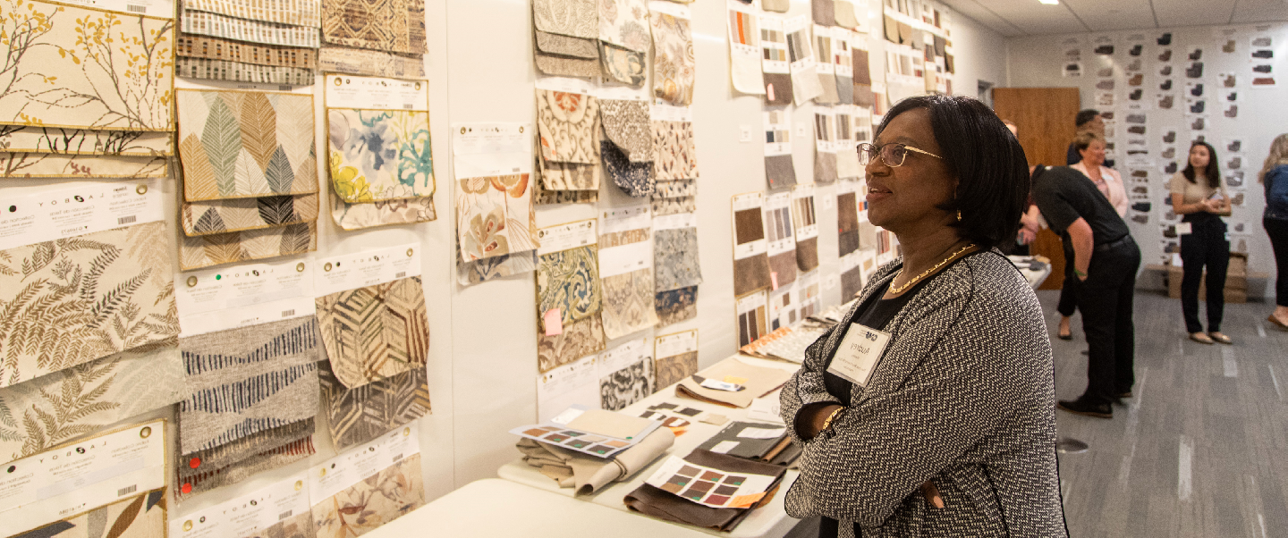 Woman looking at textile samples during a tour of a La-Z-Boy building