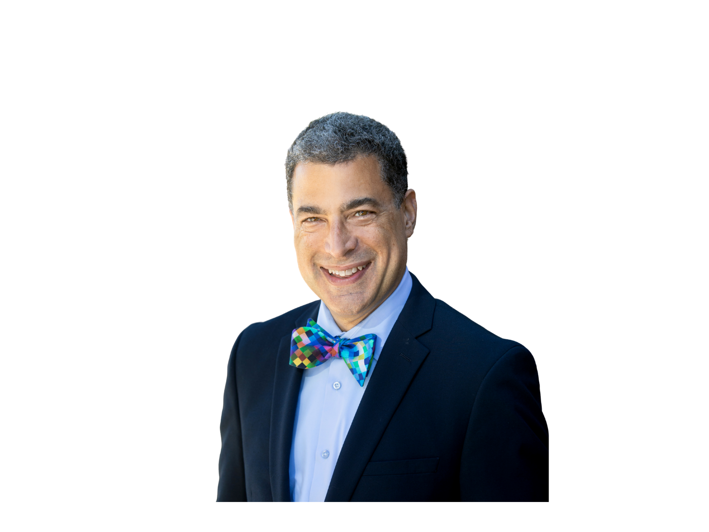 Kyle is smiling at the camera wearing a suit and a bow tie.