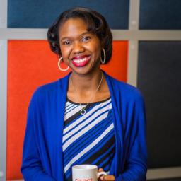 Charnae Sanders wearing a blue sweater and striped top