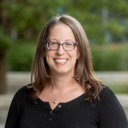 Headshot of Jennifer Ruud, wearing a black blouse and smiling