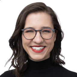 Laura Grannemann headshot, smiling wearing a black turtle neck sweater