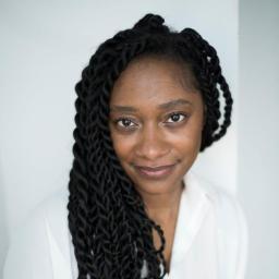 Headshot for Meredith Rogan, looking towards the camera and wearing a professional white blouse